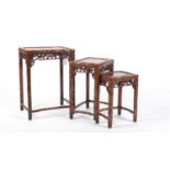 A nest of three Chinese carved huanghuali occasional tables