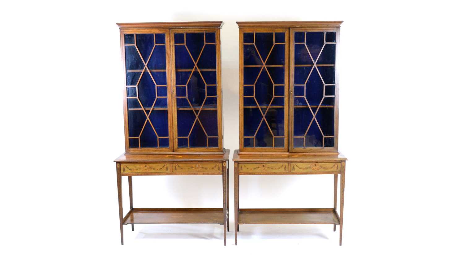 A pair of Sheraton Revival mahogany display cabinets on stand.