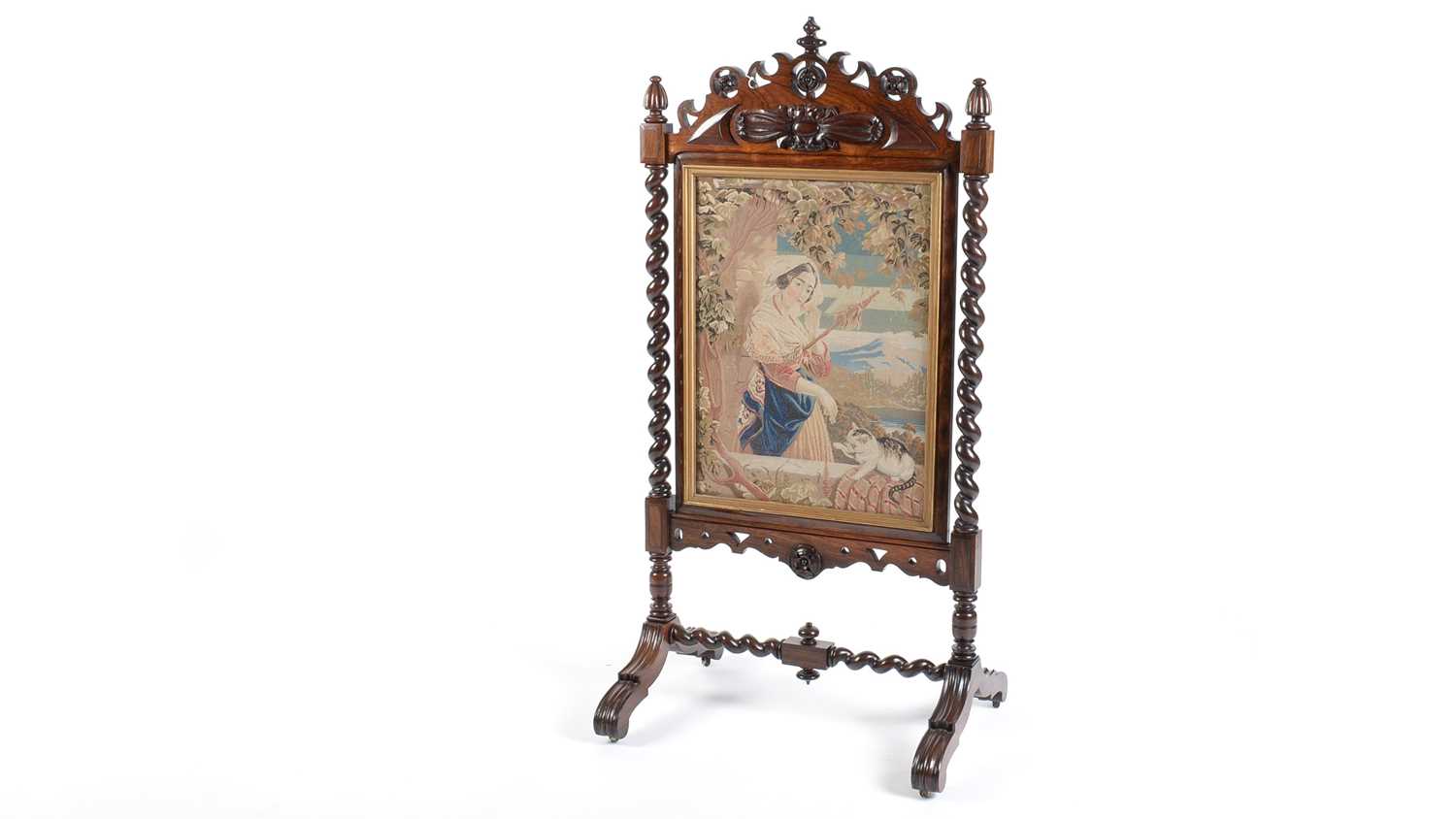 A Victorian carved rosewood firescreen.