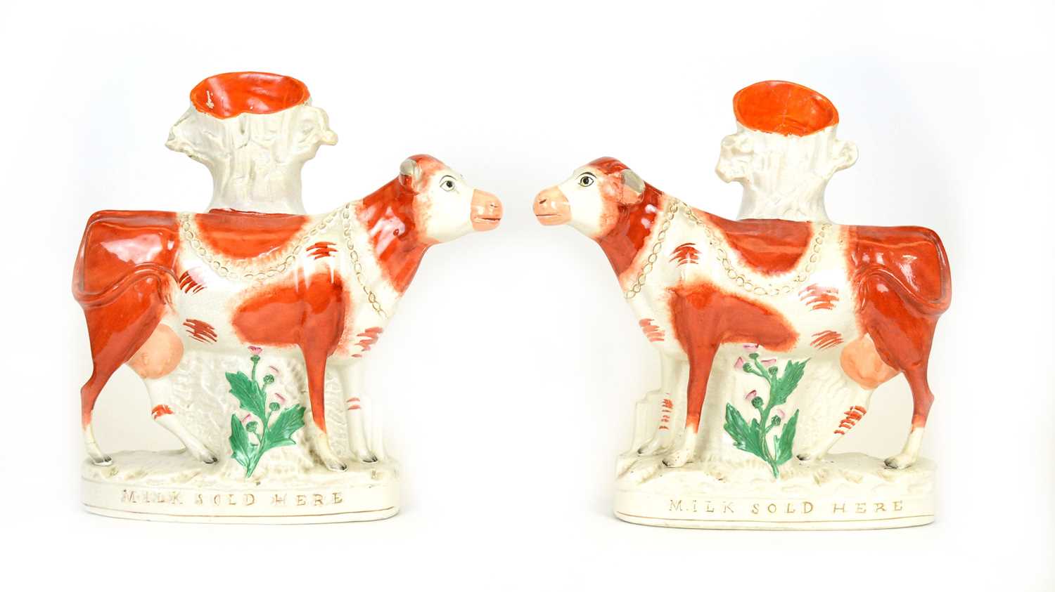 Pair of Staffordshire 'MILK SOLD HERE' cows