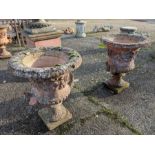 A weathered pair of cast terracotta campana urns