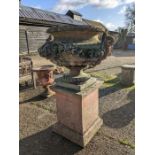 A very large weathered cast terracotta garden urn