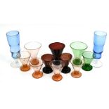 Three North African conical coloured soda-glass beakers and other glasses