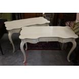 A pair of continental cream painted three drawer console tables