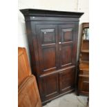 A Georgian mahogany floor standing corner cupboard