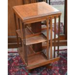 A small Edwardian walnut revolving bookcase