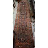 An old worn Persian Hamadan runner