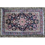 A Persian Kerman rug, 140 cm x 90 cm