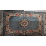 A floral design blue ground cut-wool rug, 160 cm x 91 cm