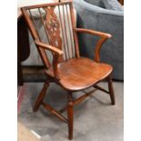 An antique elm seated wheelback elbow chair