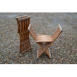 A pair of modern teak folding chairs