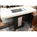 A contemporary simulated cream and black marble console table