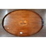 A 19th century mahogany oval butler's tray with wavy gallery