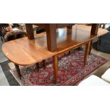 A stained wood extending dining table