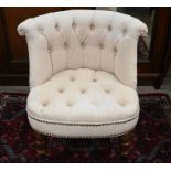 An Oka style chair with cream button-back upholstery and turned front legs with castors