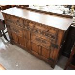 An old Charm style panelled oak sideboard