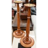 A pair of turned beech smokers stands
