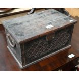 An antique carved oak strong-box with iron loop handles