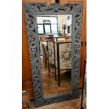 A large mirror in carved and painted frame