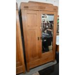 An early 20th century German Arts & Crafts light oak cupboard