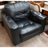 A contemporary black leather box form arm chair on brushed steel legs