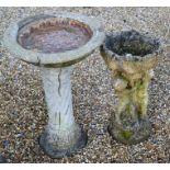 Two weathered cast stone bird baths