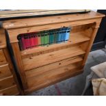 A modern stained pine bookcase with three open shelves