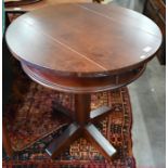 A stained hardwood circular lamp table