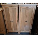 A pair of light oak cabinets