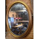 An oval gilt framed mirror