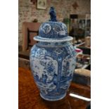 A large Delft vase of reeded ovoid form, the domed cover with lion finial