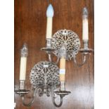 A pair of Carolean-style ep twin-branch wall sconces with foliate-pierced back plates