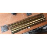 A set of fifteen Victorian hollow brass stair-rods with trefoil finials