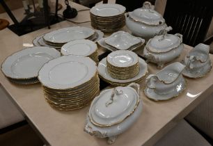 A German porcelain dinner service for twelve with gilt rims