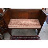 An early 20th century panelled oak settle