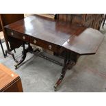 A Regency mahogany and ebony strung sofa table