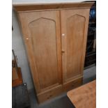 An antique pine wardrobe