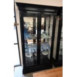 A large ebonised glazed display cabinet