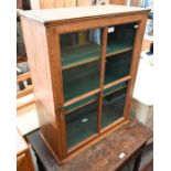 An antique stripped pine display cabinet