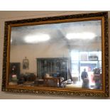 A gilt framed wall mirror