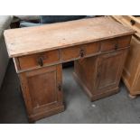 A small Victorian pine kneehole desk