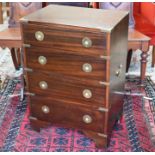 A small reproduction mahogany and brass mounted campaign style four drawer chest