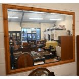 A large modern pine framed mirror