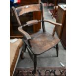 An antique provincial elm seated elbow chair