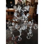 A wrought metal electrolier hung wtih faceted glass drops