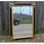 A Victorian style ebonised and gilt bevel edged wall mirror