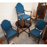 A stained oak circular table and three chairs