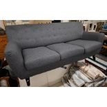 A contemporary three seater sofa charcoal grey button back upholstery