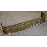 An antique fret pierced brass fender