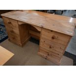 A modern stained pine kneehole desk